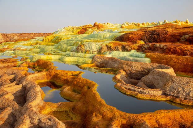 Slide 15 of 31: Ethiopia's forbidding answer to Yellowstone, the Danakil Depression is full of technicolor springs, volcanoes, salt plains, geysers, and other alien features. The area has seen temperatures as high as 122 degrees, but extreme heat isn't the only danger: The area is 