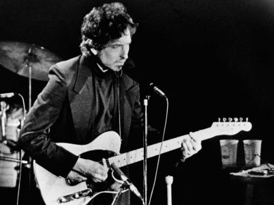 Singer Bob Dylan strums his guitar to the
