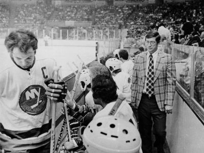 Al Arbour paces behind the bench during a