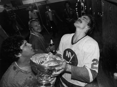 Bob Nystrom drinking from the Stanley cup after