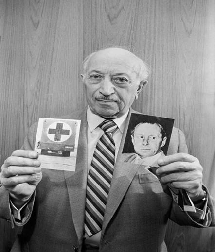 Nazi hunter Simon Wiesenthal holding photographs depicting former Gestapo chief Walter Rauff and a mobile gas-chamber van he created to execute Jews. Rauff was protected from prosecution by Chilean president Augusto Pinochet. (Credit: Bettmann Archive/Getty Images)